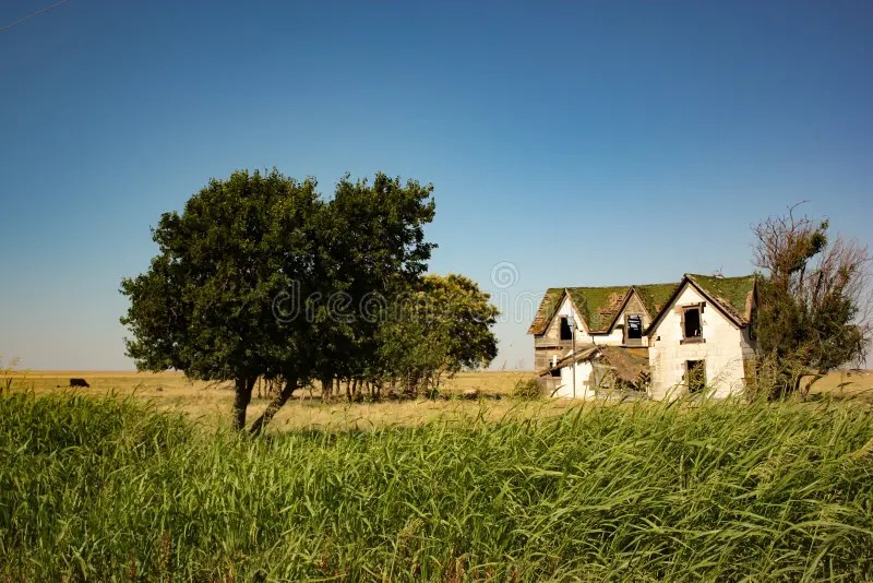 Dilapidated Abandoned Farm House In A Field In Oklahoma